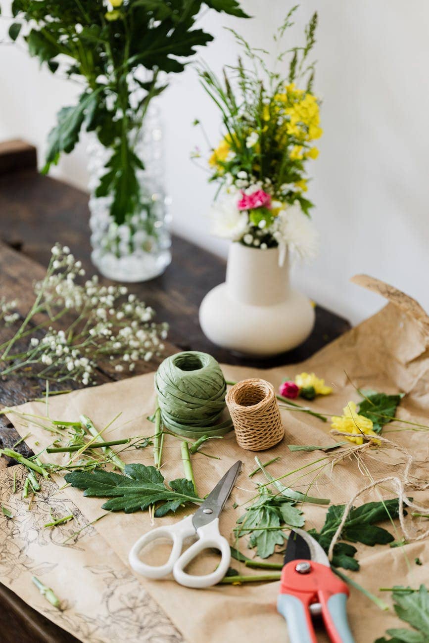 messy table with bouquets in florists creative workplace